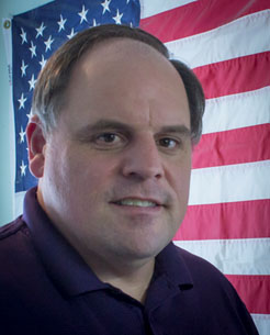 Portrait of Rob Callahan with a U.S. Flag in the background